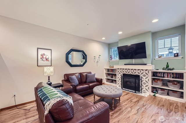 10829 19th Ave SE Unit 3C, Everett, WA 98208 - living room with wood finished floors, baseboards, recessed lighting, and a tiled fireplace