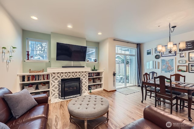 10829 19th Ave SE Unit 3C, Everett, WA 98208 - living area with a chandelier, wood finished floors, a tile fireplace, recessed lighting, and baseboards