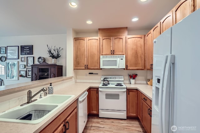 10829 19th Ave SE Unit 3C, Everett, WA 98208 - kitchen with white appliances, a sink, light wood finished floors, recessed lighting, and light countertops