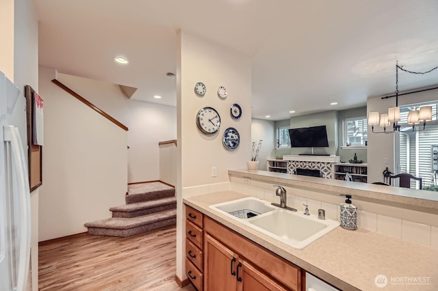 10829 19th Ave SE Unit 3C, Everett, WA 98208 - kitchen featuring a sink, light wood-type flooring, light countertops, freestanding refrigerator, and recessed lighting