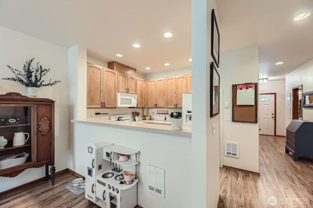 10829 19th Ave SE Unit 3C, Everett, WA 98208 - kitchen with white appliances, light wood finished floors, light countertops, light brown cabinets, and recessed lighting