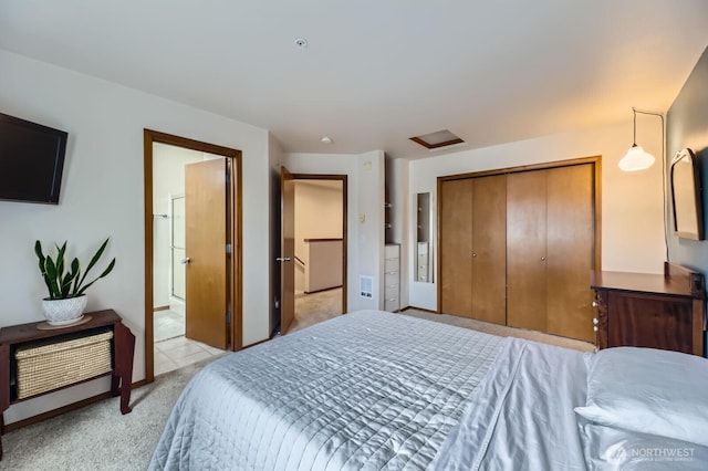 10829 19th Ave SE Unit 3C, Everett, WA 98208 - bedroom featuring light carpet, a closet, attic access, and connected bathroom
