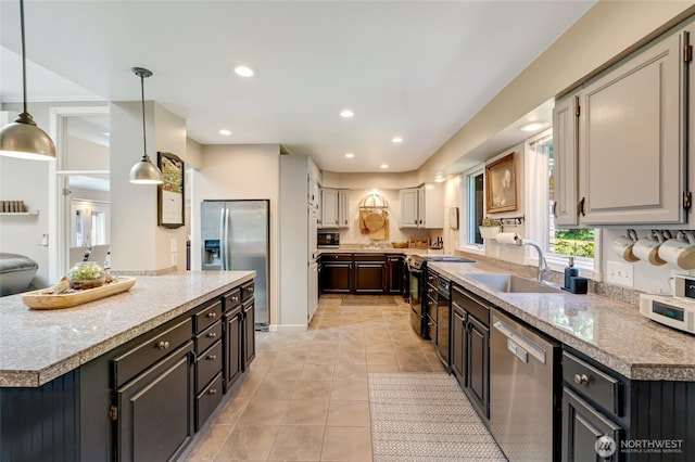 19716 61st Ave SE, Snohomish, WA 98296 - kitchen with appliances with stainless steel finishes, a sink, a center island, light tile patterned floors, and pendant lighting