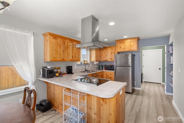 505 Herren Ave, Winlock, WA 98596 - kitchen with freestanding refrigerator, island range hood, a sink, light countertops, and light wood-style flooring
