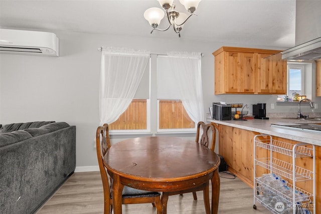 505 Herren Ave, Winlock, WA 98596 - dining area with a wall mounted AC, light wood finished floors, and a chandelier