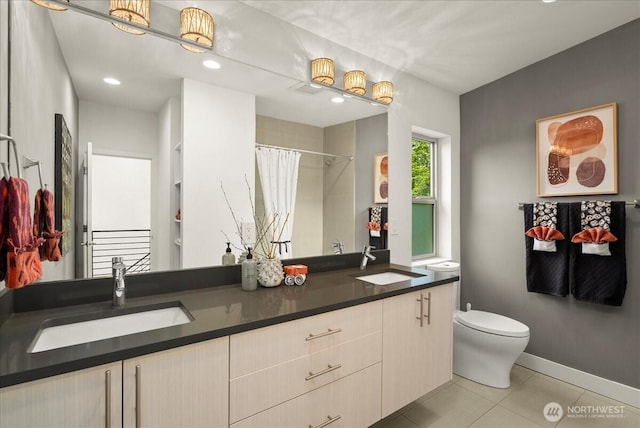 4531 S Kenny St, Seattle, WA 98118 - full bathroom with toilet, double vanity, tile patterned flooring, a shower with shower curtain, and baseboards