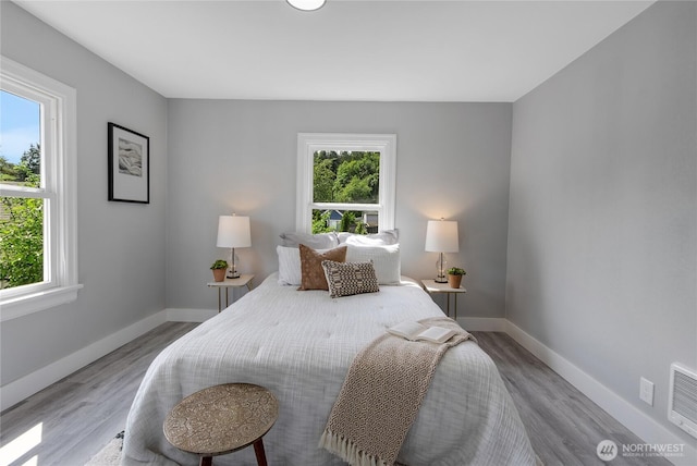 4224 Division Ave W, Bremerton, WA 98312 - bedroom with multiple windows, wood finished floors, and baseboards