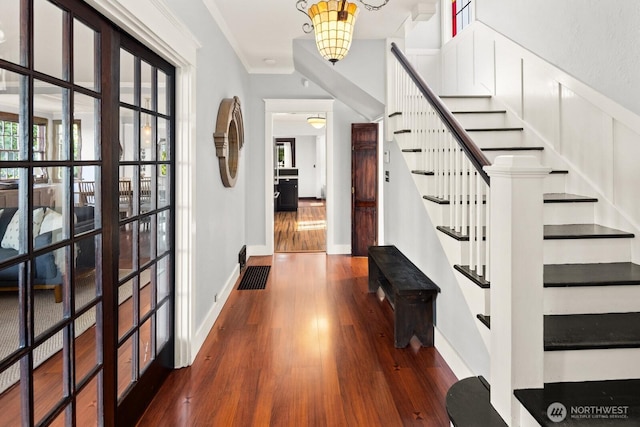 3201 SW Genesee St, Seattle, WA 98126 - foyer entrance with dark wood finished floors, stairs, a chandelier, baseboards, and ornamental molding