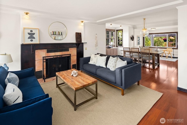 3201 SW Genesee St, Seattle, WA 98126 - living room with wood finished floors, crown molding, and a tiled fireplace