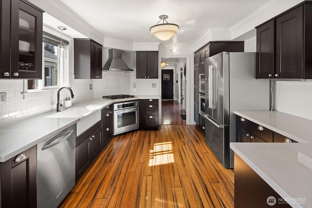 3201 SW Genesee St, Seattle, WA 98126 - kitchen with wall chimney range hood, stainless steel appliances, a sink, backsplash, and ornamental molding