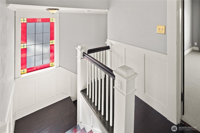3201 SW Genesee St, Seattle, WA 98126 - staircase featuring a decorative wall, wainscoting, and wood finished floors