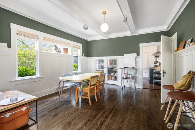 410 N 48th St, Seattle, WA 98103 - dining room featuring dark wood-style flooring, a decorative wall, beamed ceiling, a wainscoted wall, and crown molding