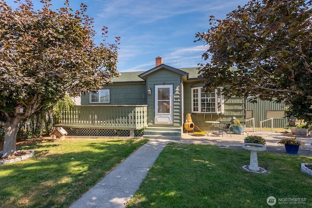 30 Hemlock St N, Soap Lake, WA 98851 - view of front facade with a chimney, a deck, a front yard, and a shingled roof