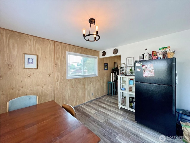 30 Hemlock St N, Soap Lake, WA 98851 - dining space with a chandelier, wood finished floors, and wood walls