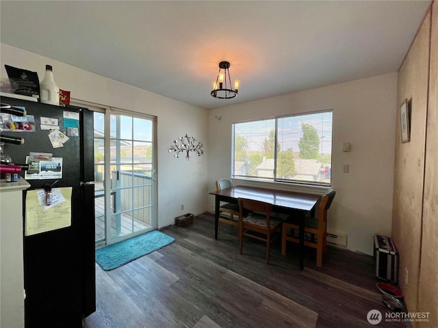 30 Hemlock St N, Soap Lake, WA 98851 - dining room with wood finished floors, plenty of natural light, a chandelier, and a baseboard radiator