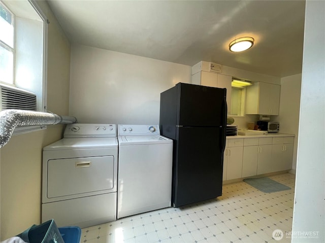 30 Hemlock St N, Soap Lake, WA 98851 - laundry room with light flooring, washer and clothes dryer, and cabinet space