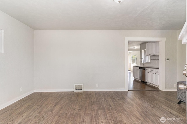 4035 A St, Tacoma, WA 98418 - unfurnished living room featuring dark wood-style flooring, baseboards, and a sink
