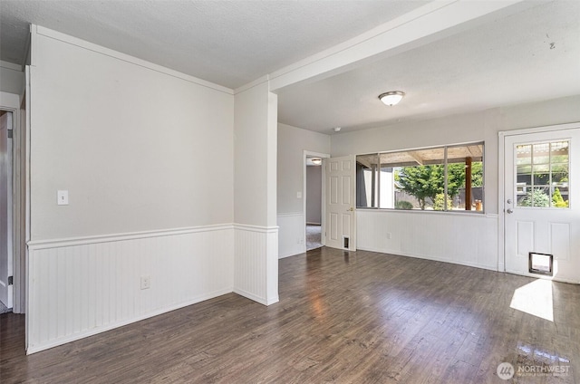 4035 A St, Tacoma, WA 98418 - empty room with wood finished floors, wainscoting, healthy amount of natural light, and a textured ceiling