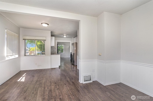 4035 A St, Tacoma, WA 98418 - empty room with dark wood-type flooring, wainscoting, and a sink