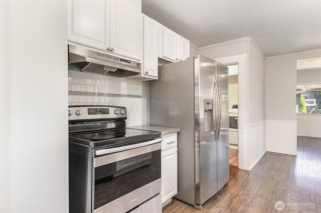 4035 A St, Tacoma, WA 98418 - kitchen with stainless steel appliances, under cabinet range hood, light wood-type flooring, white cabinets, and washer / clothes dryer