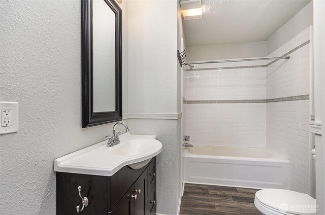 4035 A St, Tacoma, WA 98418 - full bathroom featuring vanity, a textured wall, wood finished floors, toilet, and bathing tub / shower combination