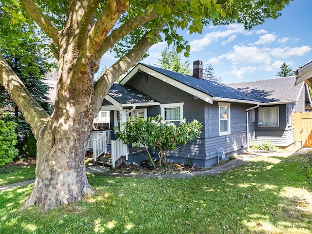 4035 A St, Tacoma, WA 98418 - view of front facade featuring a chimney, a front yard, and a shingled roof