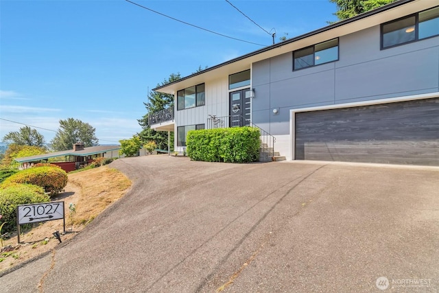 21027 7th Pl S, Des Moines, WA 98198 - view of front facade with asphalt driveway and a garage