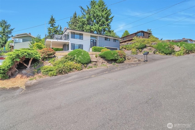 21027 7th Pl S, Des Moines, WA 98198 - view of front of house with stairs, a balcony, and a carport