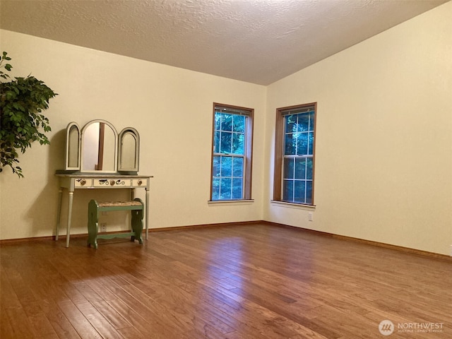 8322 Shoemaker Rd, Tulalip, WA 98271 - empty room with wood finished floors, baseboards, and a textured ceiling