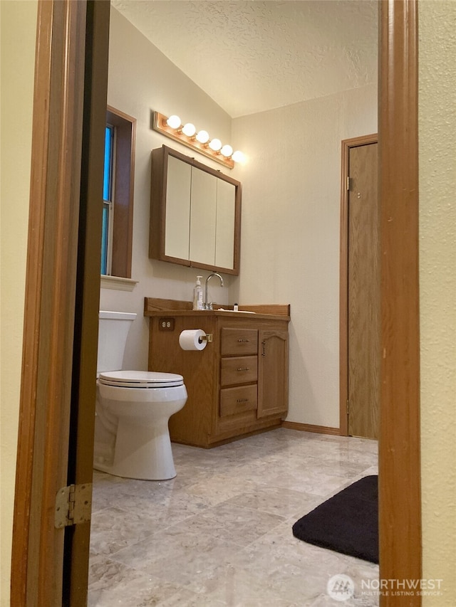 8322 Shoemaker Rd, Tulalip, WA 98271 - bathroom featuring toilet, vanity, and a textured ceiling