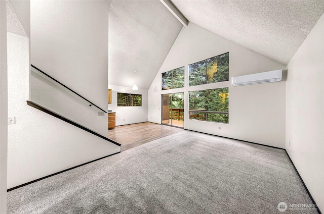 33 N Summit Dr, Bellingham, WA 98229 - unfurnished living room featuring high vaulted ceiling, carpet flooring, an AC wall unit, beamed ceiling, and a textured ceiling