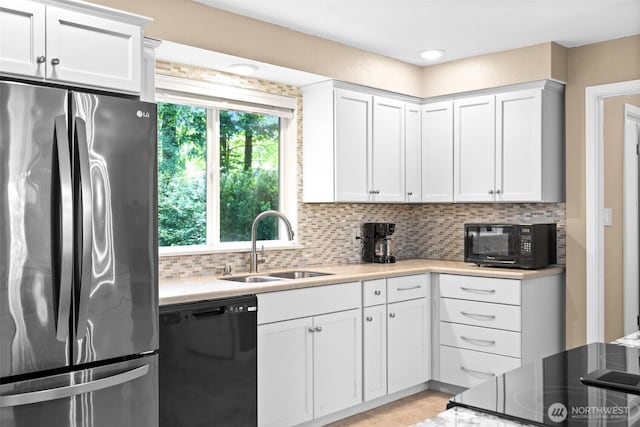 25721 173rd Ave SE, Covington, WA 98042 - kitchen with black appliances, a sink, backsplash, white cabinets, and light countertops