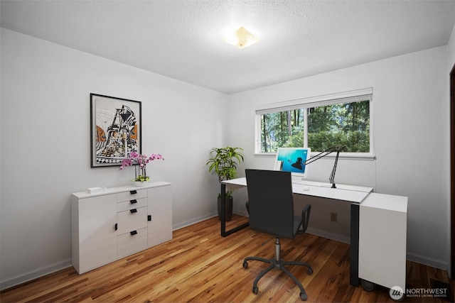 25721 173rd Ave SE, Covington, WA 98042 - home office with wood finished floors, baseboards, and a textured ceiling