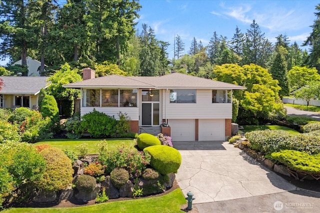 17554 12th Ave NW, Shoreline, WA 98177 - raised ranch featuring a garage, concrete driveway, a chimney, and a front yard