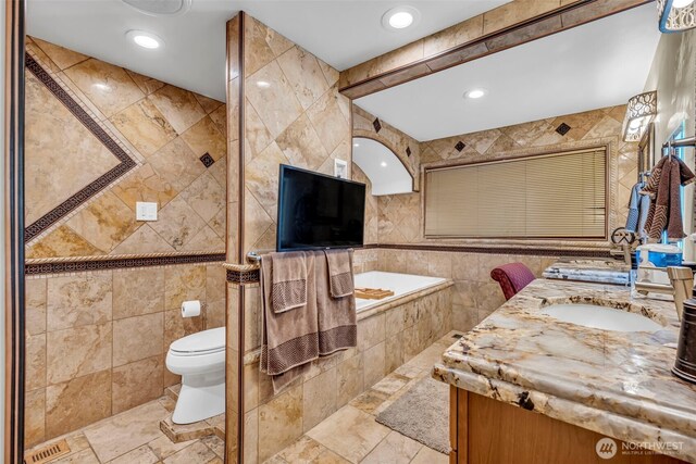 6490 NE Monte Vista Dr, Bainbridge Island, WA 98110 - full bathroom with tile walls, vanity, toilet, a relaxing tiled tub, and recessed lighting