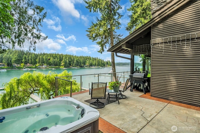 6490 NE Monte Vista Dr, Bainbridge Island, WA 98110 - view of patio / terrace featuring a water view, a hot tub, and a view of trees