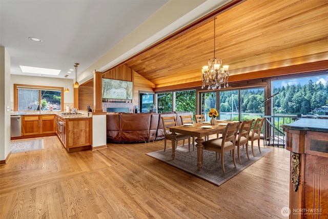 6490 NE Monte Vista Dr, Bainbridge Island, WA 98110 - dining area featuring vaulted ceiling, a skylight, light wood-style flooring, a chandelier, and recessed lighting