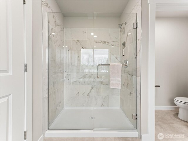 8310 115th Pl SE Unit 3, Newcastle, WA 98056 - bathroom featuring a shower stall, toilet, and baseboards
