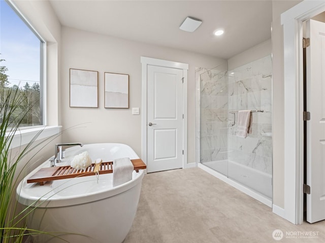 8310 115th Pl SE Unit 3, Newcastle, WA 98056 - full bath with a freestanding bath, a marble finish shower, plenty of natural light, baseboards, and recessed lighting