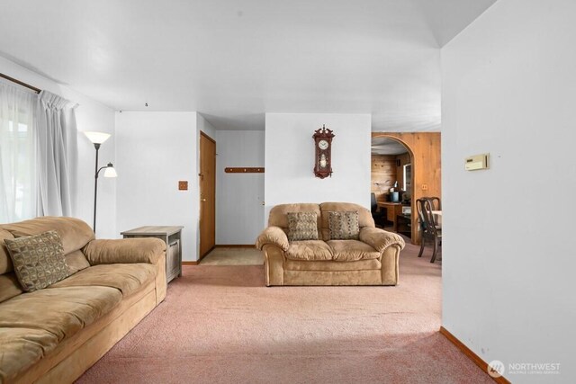 11939 SE 169th Pl, Renton, WA 98058 - carpeted living room with arched walkways, baseboards, and wooden walls