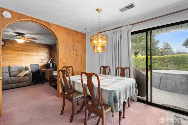 11939 SE 169th Pl, Renton, WA 98058 - dining room featuring wood walls, carpet floors, a ceiling fan, arched walkways, and an office area