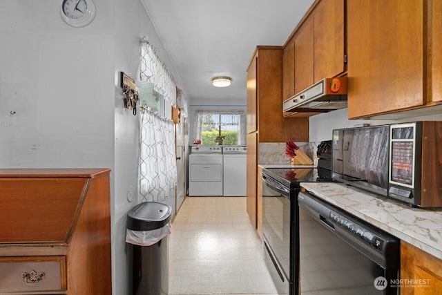 11939 SE 169th Pl, Renton, WA 98058 - kitchen with washing machine and dryer, black appliances, under cabinet range hood, light flooring, and brown cabinetry