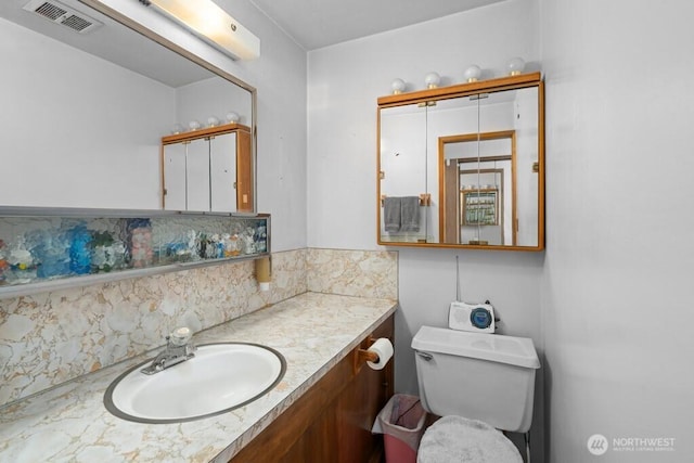 11939 SE 169th Pl, Renton, WA 98058 - bathroom featuring vanity, decorative backsplash, and toilet