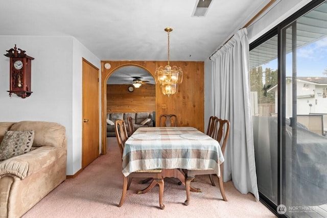 11939 SE 169th Pl, Renton, WA 98058 - dining room featuring light carpet, wooden walls, and a chandelier