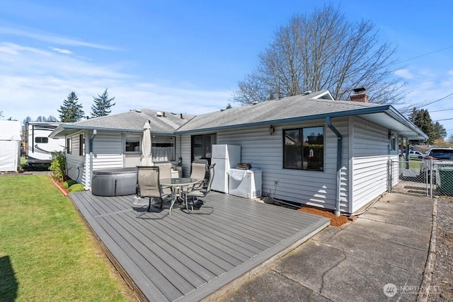 11939 SE 169th Pl, Renton, WA 98058 - back of property featuring a wooden deck, a chimney, outdoor dining area, a lawn, and a gate
