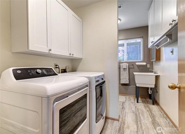 608 Harvest Rd, Bothell, WA 98012 - laundry area featuring separate washer and dryer, cabinet space, and light wood-style flooring