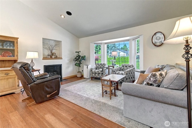 608 Harvest Rd, Bothell, WA 98012 - living area with light wood-type flooring, a fireplace with flush hearth, high vaulted ceiling, and recessed lighting