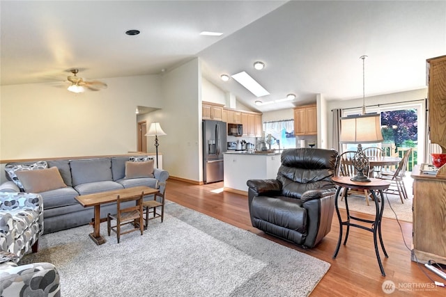 608 Harvest Rd, Bothell, WA 98012 - living room featuring vaulted ceiling, light wood-style floors, ceiling fan, and a skylight