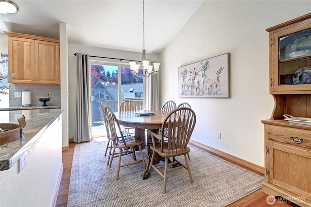 608 Harvest Rd, Bothell, WA 98012 - dining room featuring a chandelier, light wood finished floors, and lofted ceiling