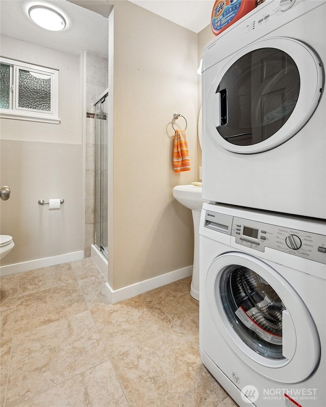 1417 S 263rd Pl, Des Moines, WA 98198 - washroom with stacked washer and clothes dryer and baseboards